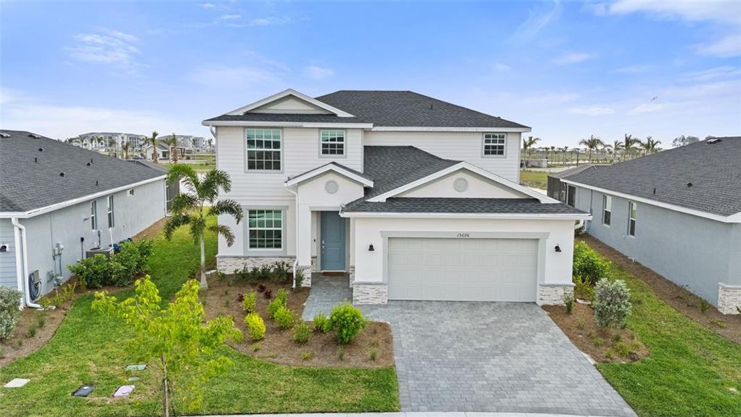 Front exterior of a new home in Tuckers Cove: Villas, Punta Gorda, FL, highlighting curb appeal (Image 23).