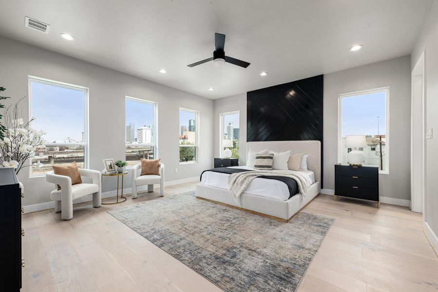 Luxurious primary suite featuring a private lounge area, offering comfort and privacy.