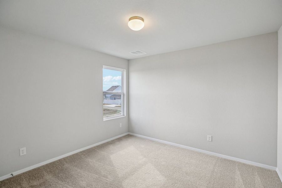 Image of a bedroom with light grey walls, tan carpeting and a window with white trim Image of a bedroom with light grey walls, tan carpeting and a window with white trim