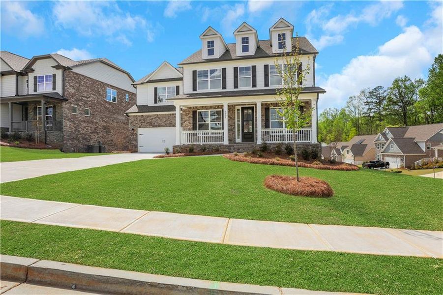 Front exterior of a new home in Cambridge, Flowery Branch, GA, highlighting curb appeal (Image 24). Front exterior of a new home in Cambridge, Flowery Branch, GA, highlighting curb appeal (Image 24).