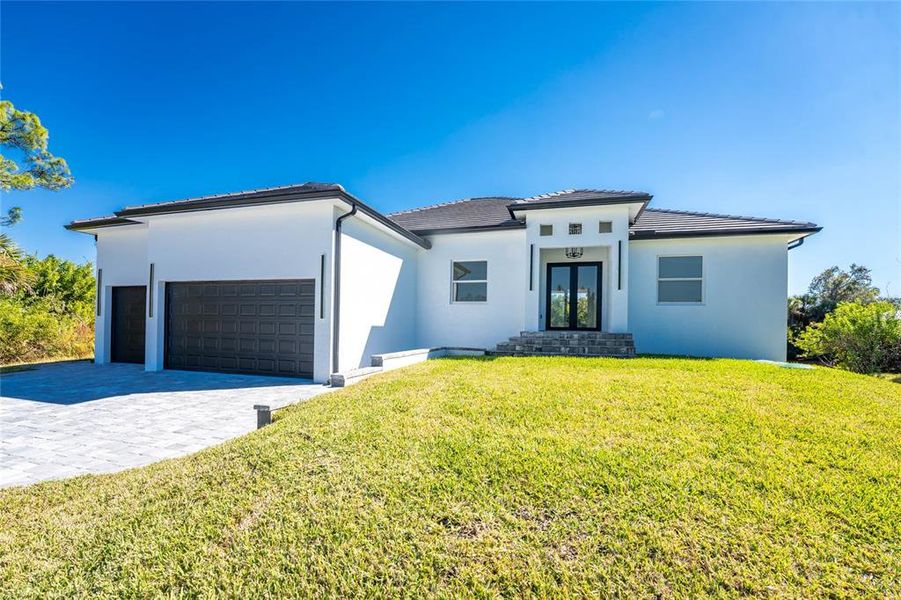 Front exterior of a new home in , Port Charlotte, FL, highlighting curb appeal (Image 2). Front exterior of a new home in , Port Charlotte, FL, highlighting curb appeal (Image 2).
