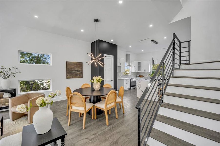 Dining area with light wood-type flooring and vaulted ceiling