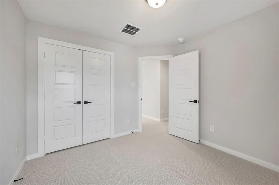 Unfurnished bedroom featuring carpet flooring and a closet