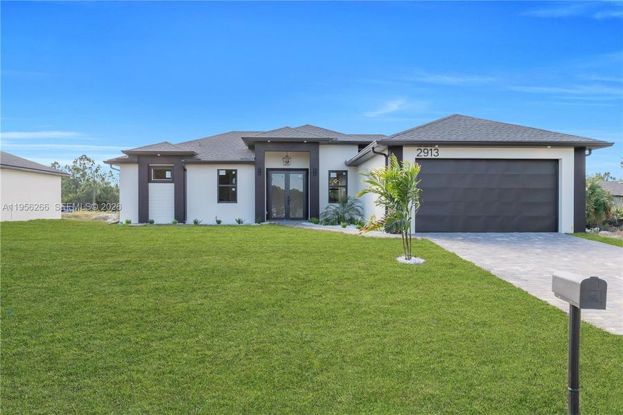 Front exterior of a new home in , Lehigh Acres, FL, highlighting curb appeal (Image 27).