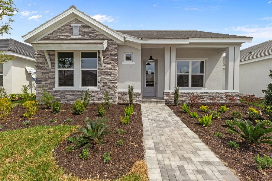 Representative exterior photo of a completed home built from the The Mapleton by David Weekley Homes in Vistera of Venice – Cottage Series, Nokomis, FL (Image 1). Representative exterior photo of a completed home built from the The Mapleton by David Weekley Homes in Vistera of Venice – Cottage Series, Nokomis, FL (Image 1).
