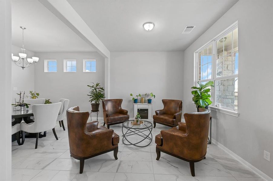 Bright modern formal living room.  Natural light streams in through multiple windows, creating a welcoming atmosphere.