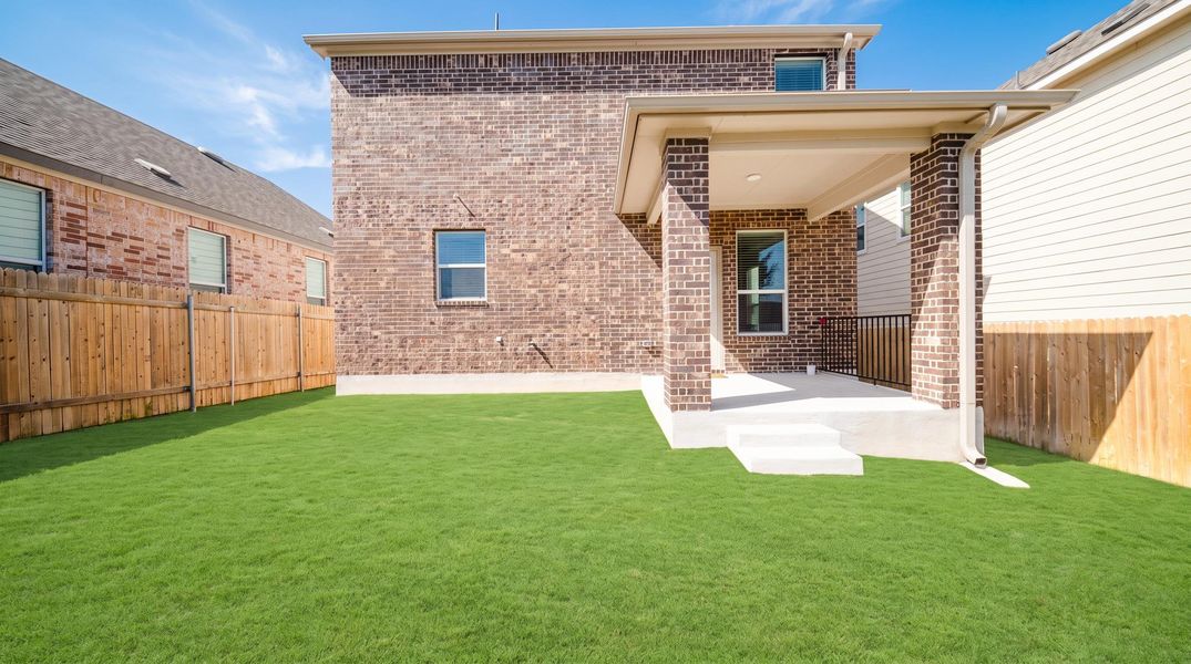 A well-maintained lawn and covered patio create a perfect outdoor living space. A well-maintained lawn and covered patio create a perfect outdoor living space.