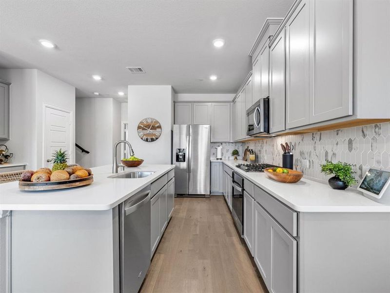 Premium Whirlpool stainless steel refrigerator is only 8 months old and stays with the home for the new buyer.