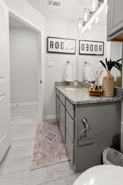 Bathroom with vanity and baseboards