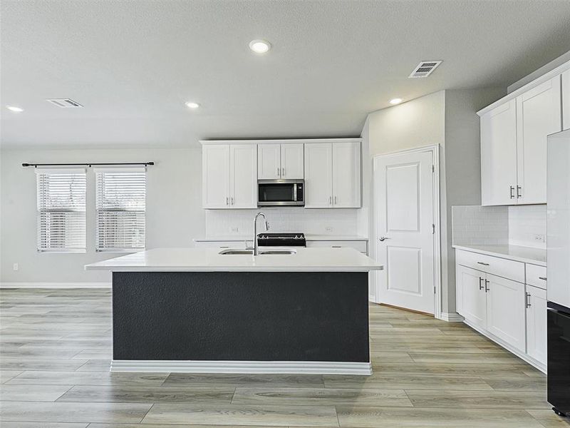 Gas range, nice-sized walk-in pantry and kitchen island make for a great day in the kitchen!