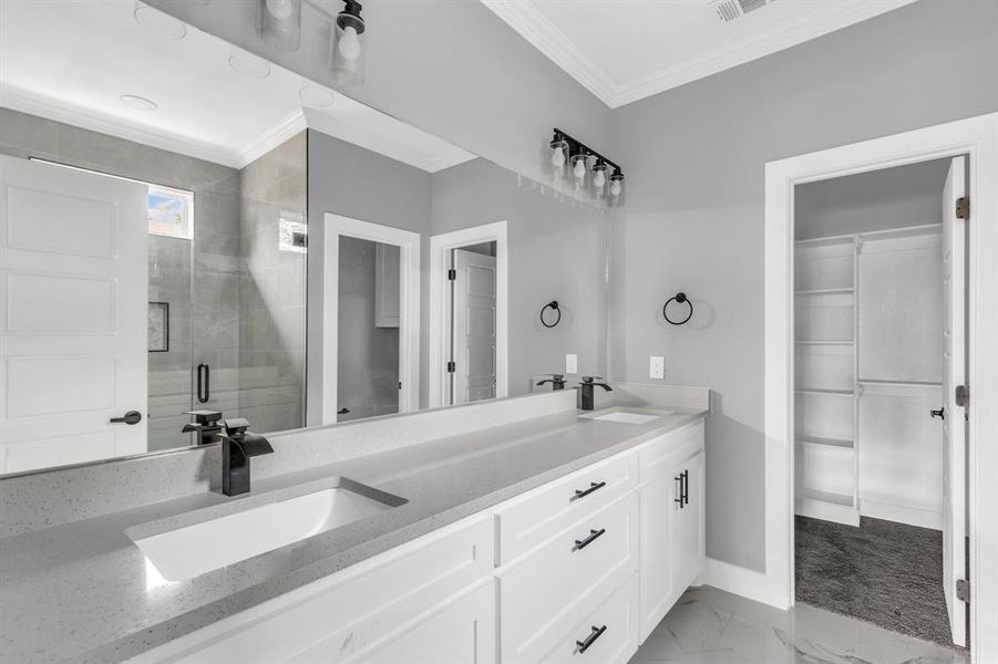 Bathroom with walk in shower, crown molding, and vanity