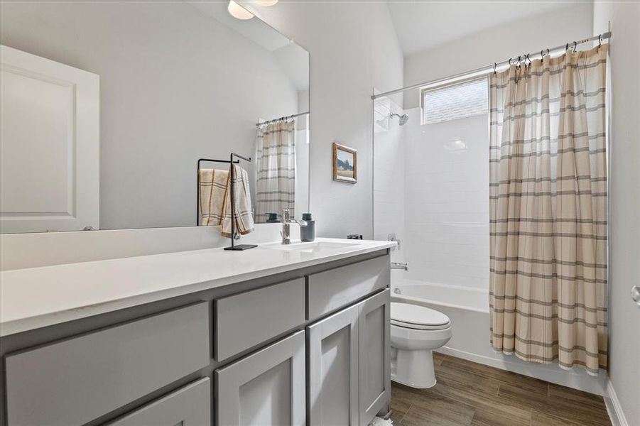 Full bathroom featuring shower / bath combo, toilet, and vanity