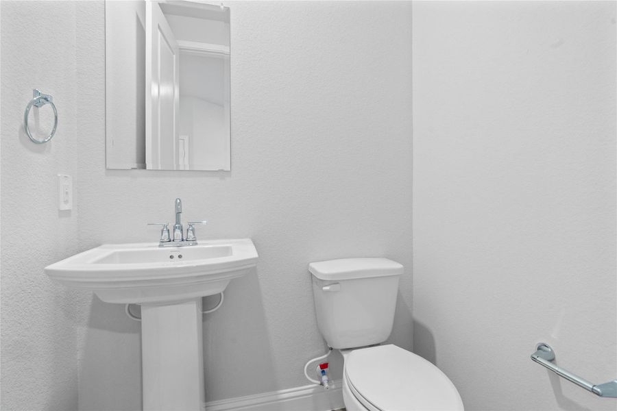 The powder bath features a stylish vanity and a clean, modern design.