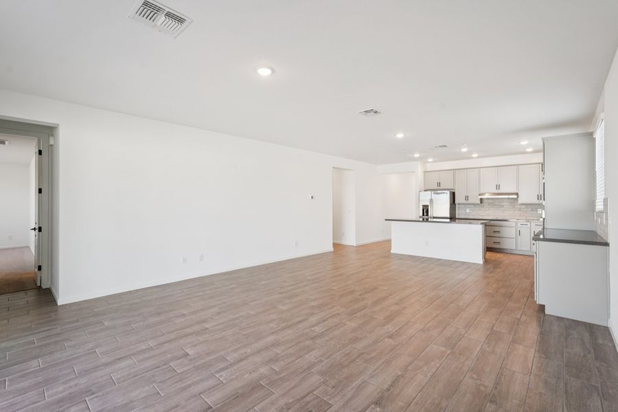 Great room, dining and kitchen. Finishes may vary by community. Great room, dining and kitchen. Finishes may vary by community.