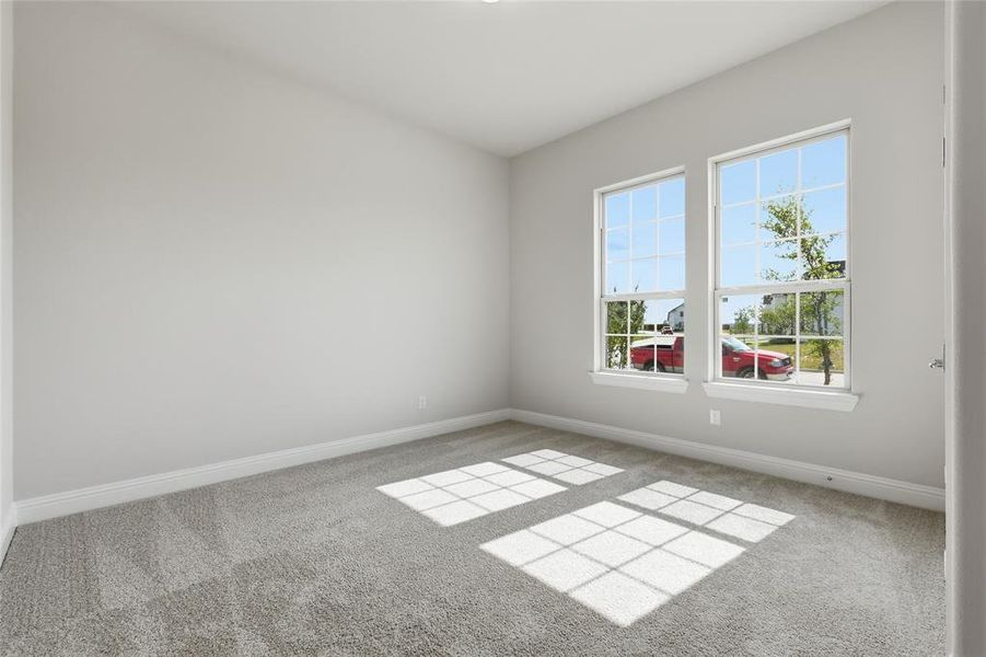 Empty room featuring baseboards and light colored carpet Empty room featuring baseboards and light colored carpet