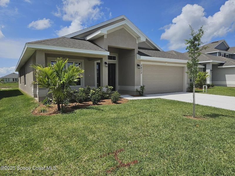 Front exterior of a new home in St. John Preserve, Palm Bay, FL, highlighting curb appeal (Image 9). Front exterior of a new home in St. John Preserve, Palm Bay, FL, highlighting curb appeal (Image 9).
