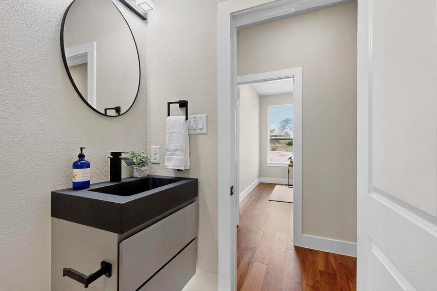 Bathroom with wood finished floors and vanity