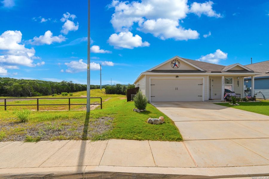 Front exterior of a new home in Hidden Trails, Bulverde, TX, highlighting curb appeal (Image 2). Front exterior of a new home in Hidden Trails, Bulverde, TX, highlighting curb appeal (Image 2).