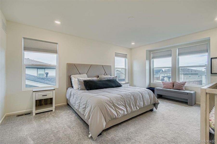 Primary bedroom has a ton of natural light