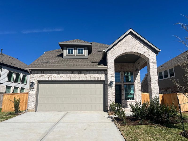 Front exterior of a new home in Wood Leaf Reserve, Tomball, TX, highlighting curb appeal (Image 14).
