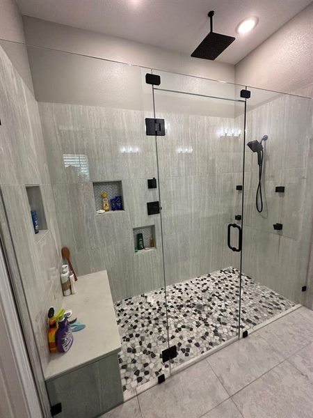 Full bathroom featuring vanity, a stall shower, and tile patterned floors
