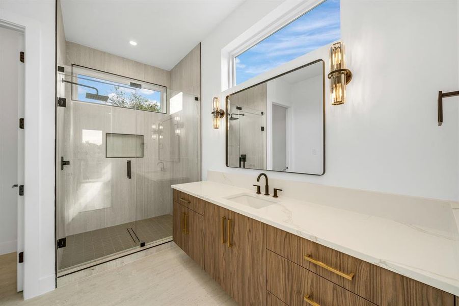 Bathroom with a shower stall and vanity