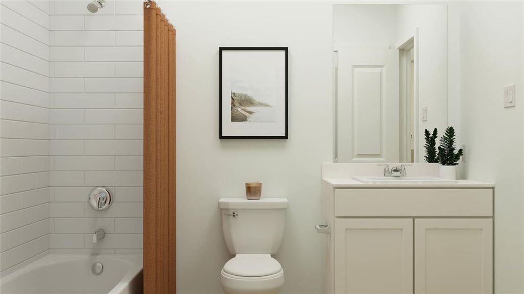 Full bathroom featuring vanity, tiled shower / bath combo, and toilet