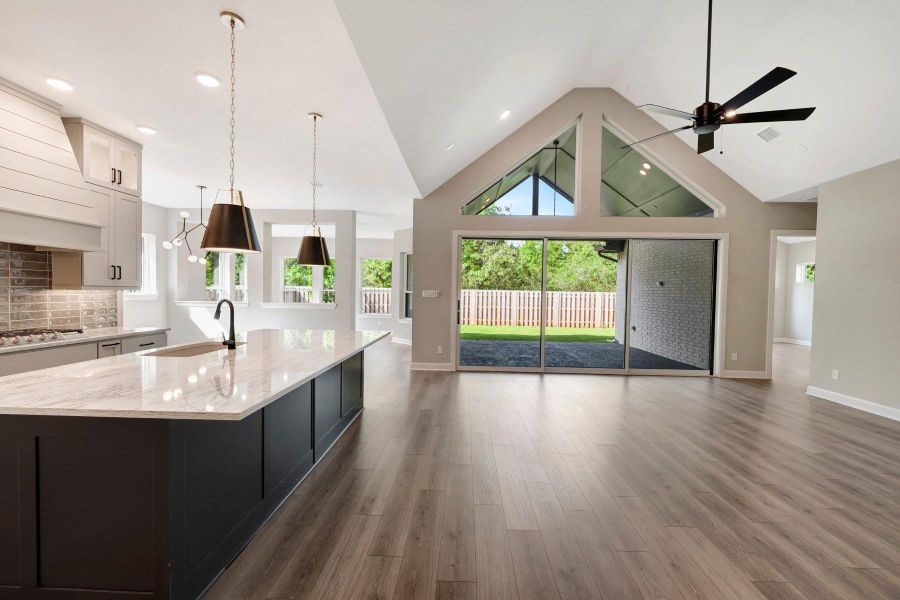 The ceilings in this home are amazing with the unique trapezoid windows and 15 ft stacking sliding glass door at Living!  It brings the outside in!