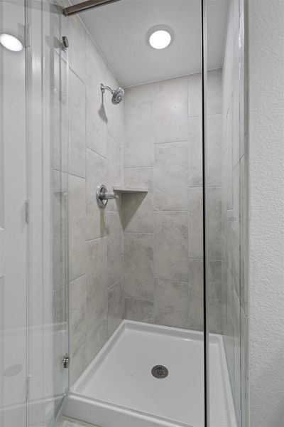 Walk-in shower with clear glass enclosure
