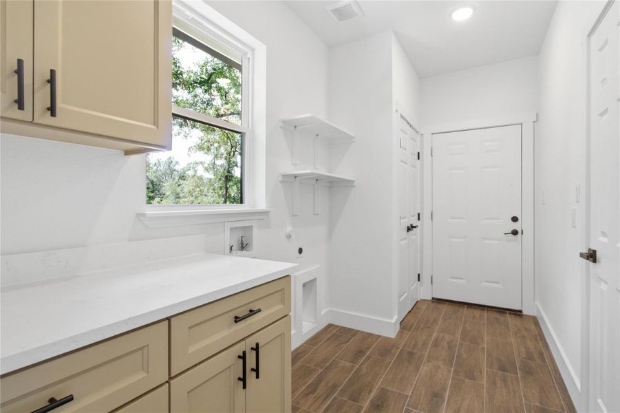 A well-appointed laundry room boasts built-in shelving, durable flooring, and ample counter space. A well-appointed laundry room boasts built-in shelving, durable flooring, and ample counter space.