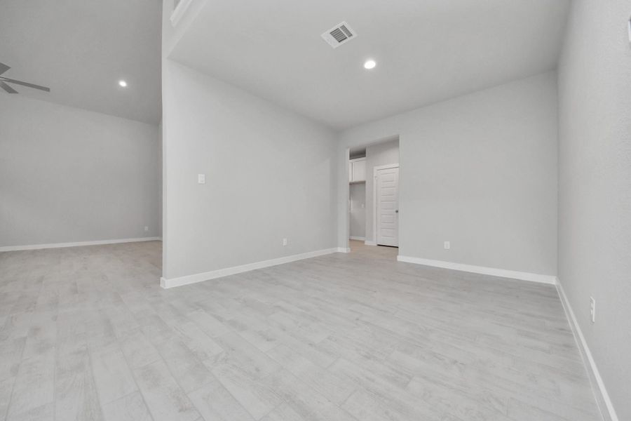 Make memories gathered around the table with your family and friends! This spacious dining room features elegant flooring, custom paint, and adjacent to family room and kitchen for open concept feel. Sample photo of completed home with similar floor plan. Actual colors and selections may vary.