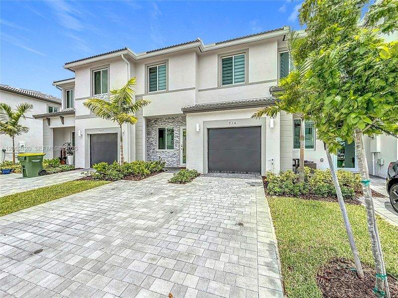 Front exterior of a new home in , Homestead, FL, highlighting curb appeal (Image 24).