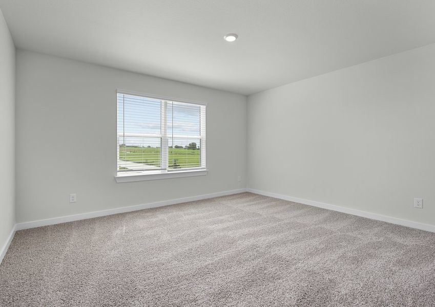 Large, spacious secondary bedroom with an oversized window.