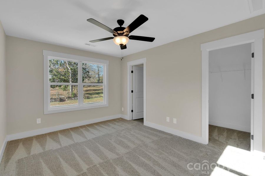 Comfortable primary bedroom with fresh carpet and neutral tones
