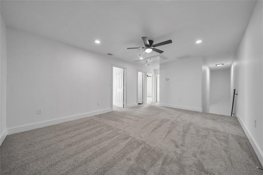 Spare room with visible vents, ceiling fan, recessed lighting, and attic access