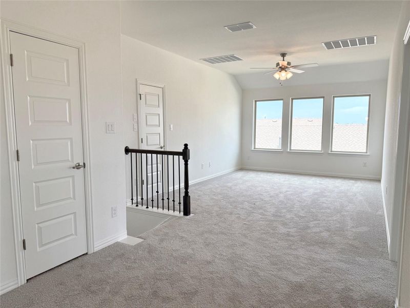Carpeted spare room featuring baseboards and ceiling fan Carpeted spare room featuring baseboards and ceiling fan