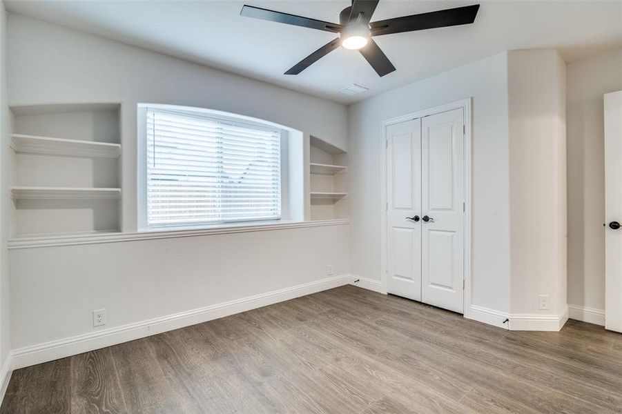 Bedroom with ceiling fan, a closet, and hardwood / wood-style floors