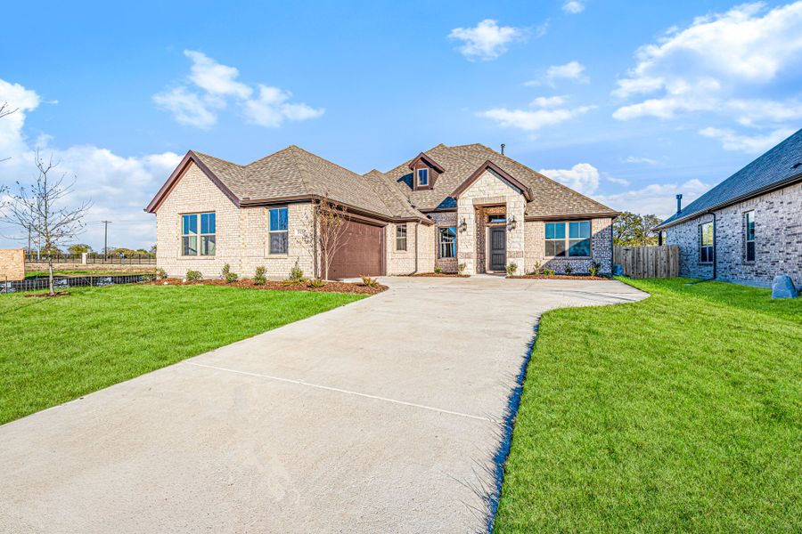 Front exterior of a new home in Forest Ridge Estates, Greenville, TX, highlighting curb appeal (Image 22).