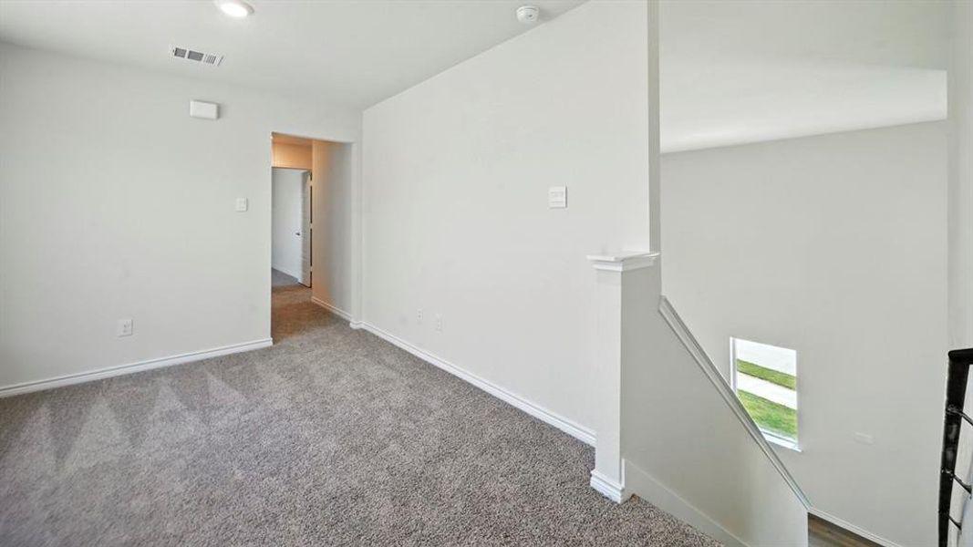 Carpeted empty room with baseboards