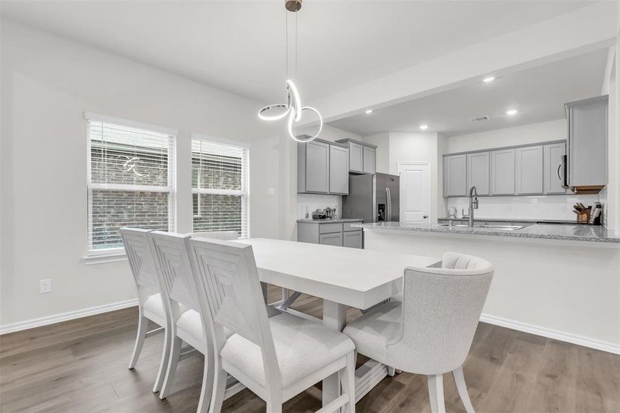 Dining area with wood finished floors, baseboards, and recessed lighting Dining area with wood finished floors, baseboards, and recessed lighting