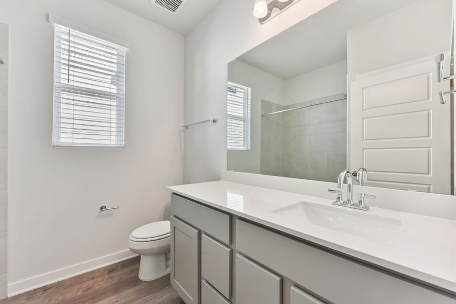 A bathroom with a large mirror. A bathroom with a large mirror.