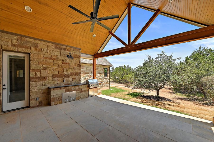 Fully covered rear patio with huge celling fan as well as a grill and outdoor cooking area.  Total privacy...no neighbors capable of seeing your backyard activities.