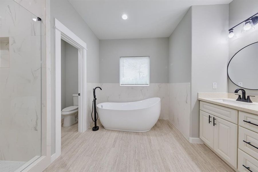 Primary bath with a luxurious soaking tub, perfect for unwinding and enjoying a relaxing, spa-like experience.