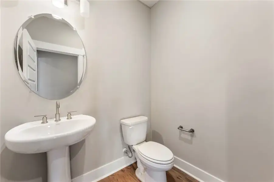 A well-appointed half bath features a modern pedes