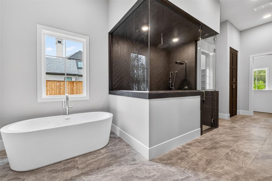 Luxury amenities are provided in the primary suite's spa-like bath, ensuring the utmost relaxation. Luxury amenities are provided in the primary suite's spa-like bath, ensuring the utmost relaxation.