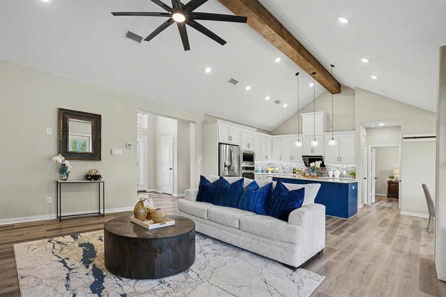 Living area featuring light wood-style flooring, a ceiling fan, and recessed lighting