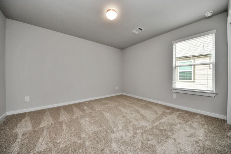 Generously sized secondary bedrooms featuring spacious closets, soft and inviting carpeting underfoot, large windows allowing plenty of natural light, and the added touch of privacy blinds for your personal retreat. Sample photo of completed home with similar floor plan. Actual colors and selections may vary.