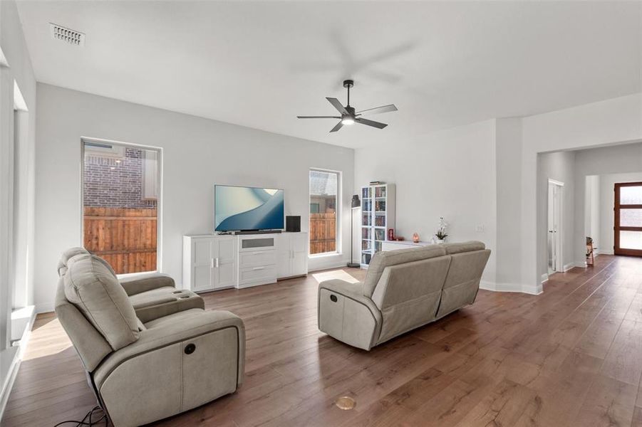 Living area with wood finished floors and a ceiling fan