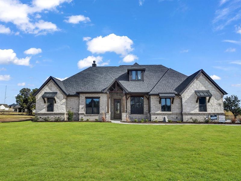 French provincial home with a front yard