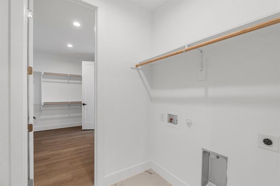 Washroom featuring electric dryer hookup, wood-type flooring, hookup for a gas dryer, and hookup for a washing machine